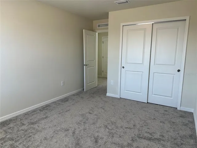 an empty room with closet area