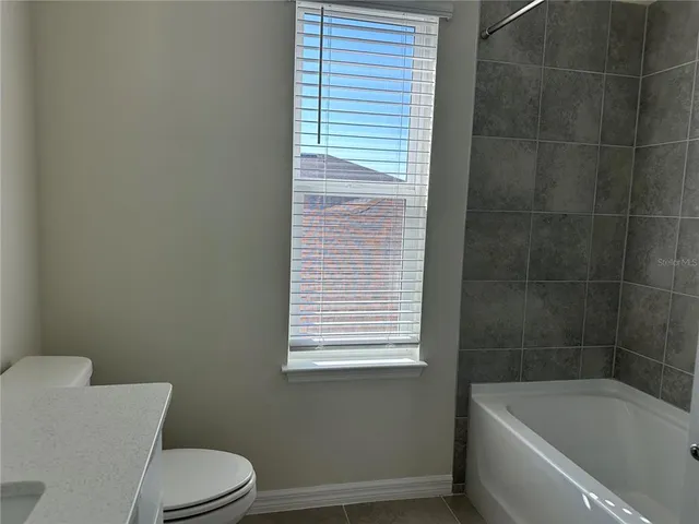 a bathroom with a toilet and bathtub