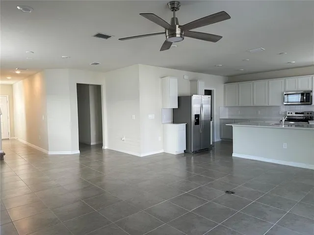 a view of a kitchen with a sink and refrigerator