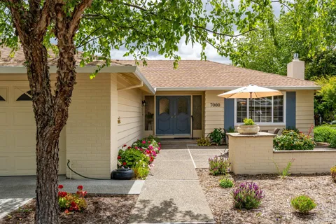 a front view of a house with a garden