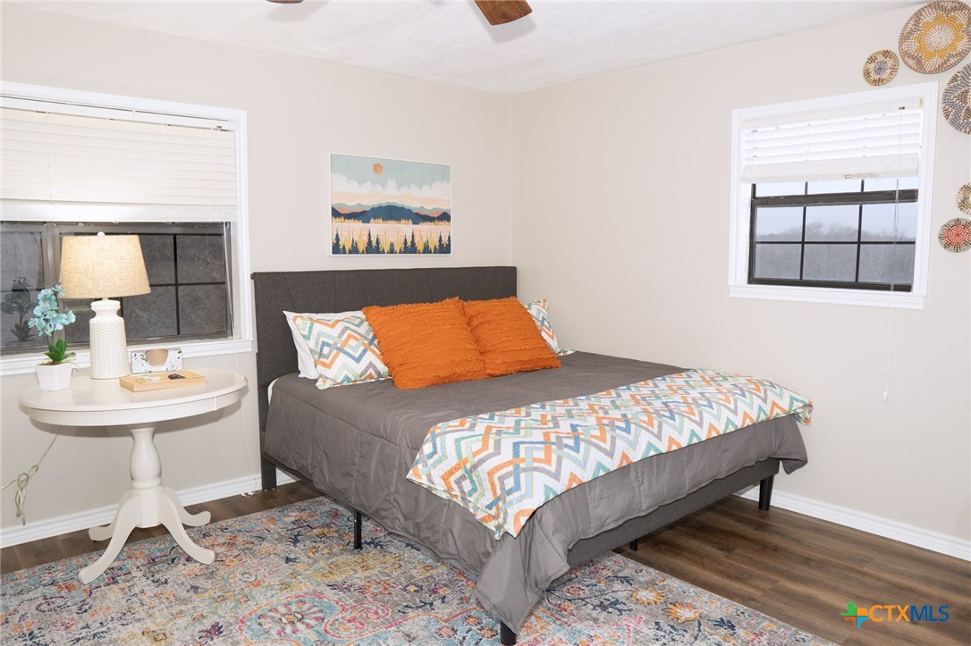 564 Cypress Valley Road Cuero, TX 77954 - Photo 26 of 40 a bedroom with a bed a mirror and lamp
