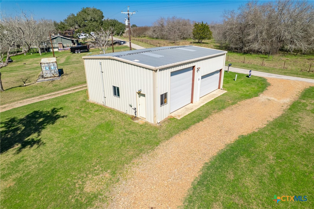 564 Cypress Valley Road Cuero, TX 77954 - Photo 31 of 40 a white house with a big yard and large trees