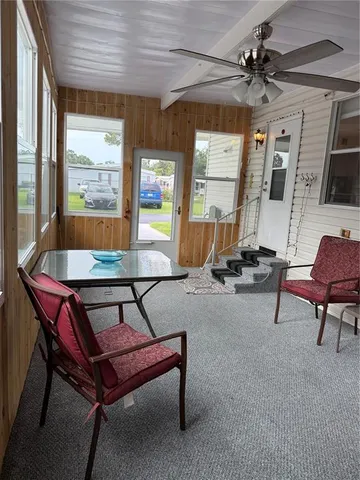 a living room with furniture a window and a ceiling fan