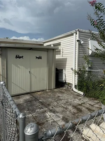 a view of a house with a small yard and plants