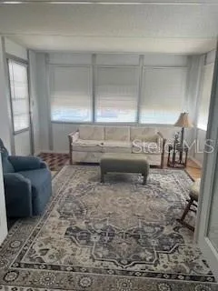 a living room with furniture window and wooden floor