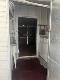 a bathroom with a walk in closet and wooden floor