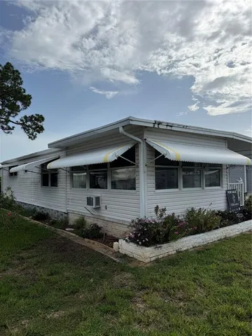 a view of a house with backyard sitting area and garden