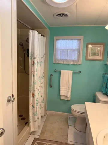 a bathroom with a toilet and a shower