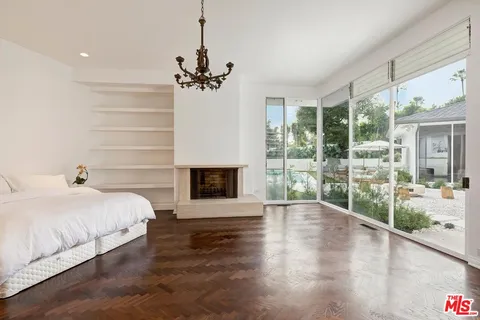 a spacious bedroom with a large bed and a fireplace