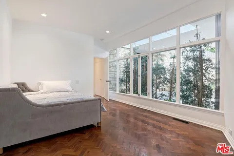 a living room with furniture and large windows
