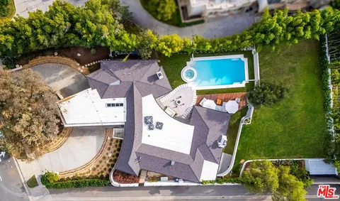 an aerial view of a house with a yard and a fountain