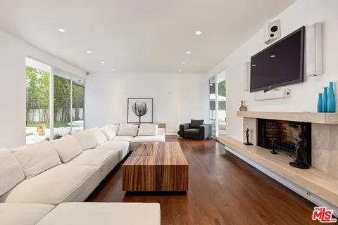 a living room with fireplace furniture and a flat screen tv