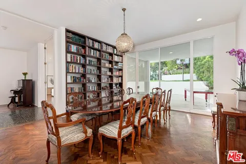 a dining room with furniture window and outside view