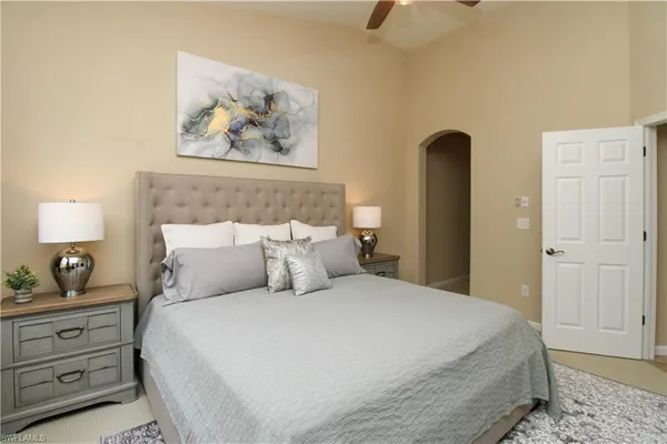 a bedroom with bed and lamps
