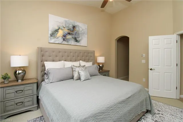 a bedroom with bed and lamps