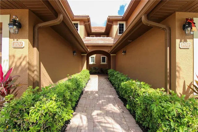 a view of a pathway both side of the house