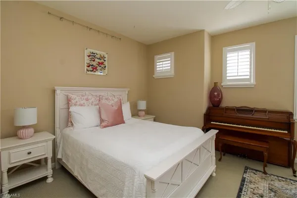 a bedroom with a bed and a potted plant