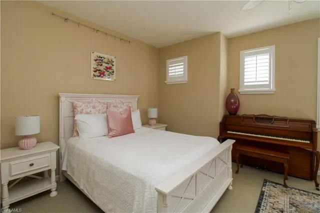 a bedroom with a bed and a potted plant