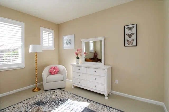 a bedroom with a bed and a dresser in it