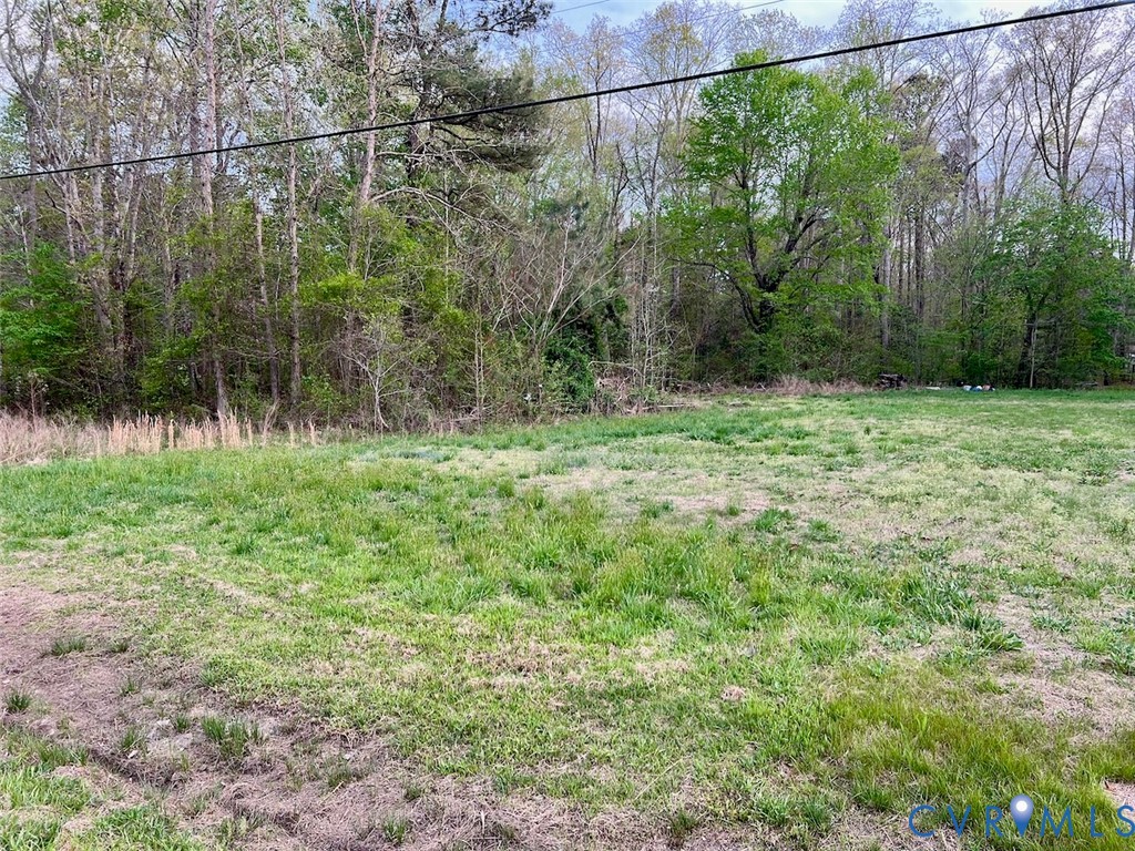 9481 Richmond Road Lanexa, VA 23089 - Photo 1 of 2 a backyard of a house with lots of green space and fountain