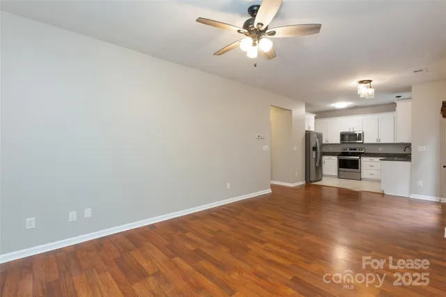 a view of kitchen with ceiling fan and wooden floor