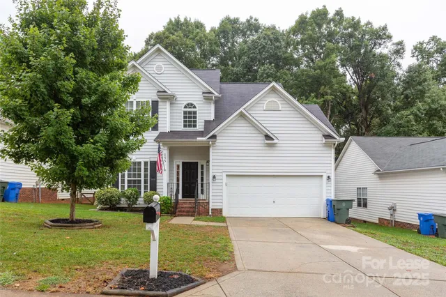 a front view of house with yard and green space