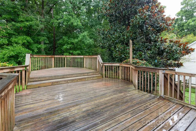 a view of backyard with deck and wooden floor