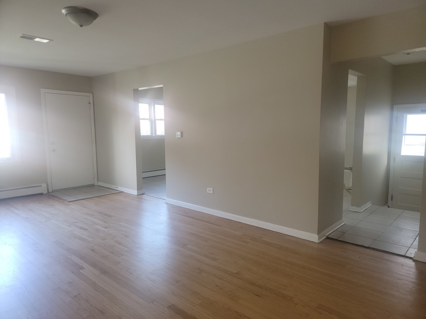 5237 West Roscoe Street Chicago, IL 60641 - Photo 5 of 27 an empty room with wooden floor and windows