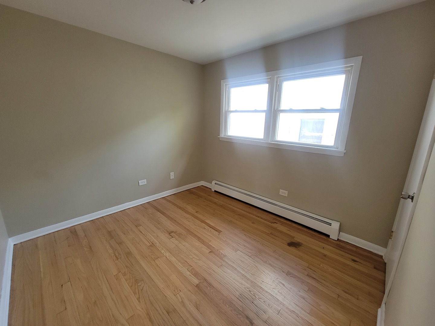 5237 West Roscoe Street Chicago, IL 60641 - Photo 9 of 27 an empty room with wooden floor and windows