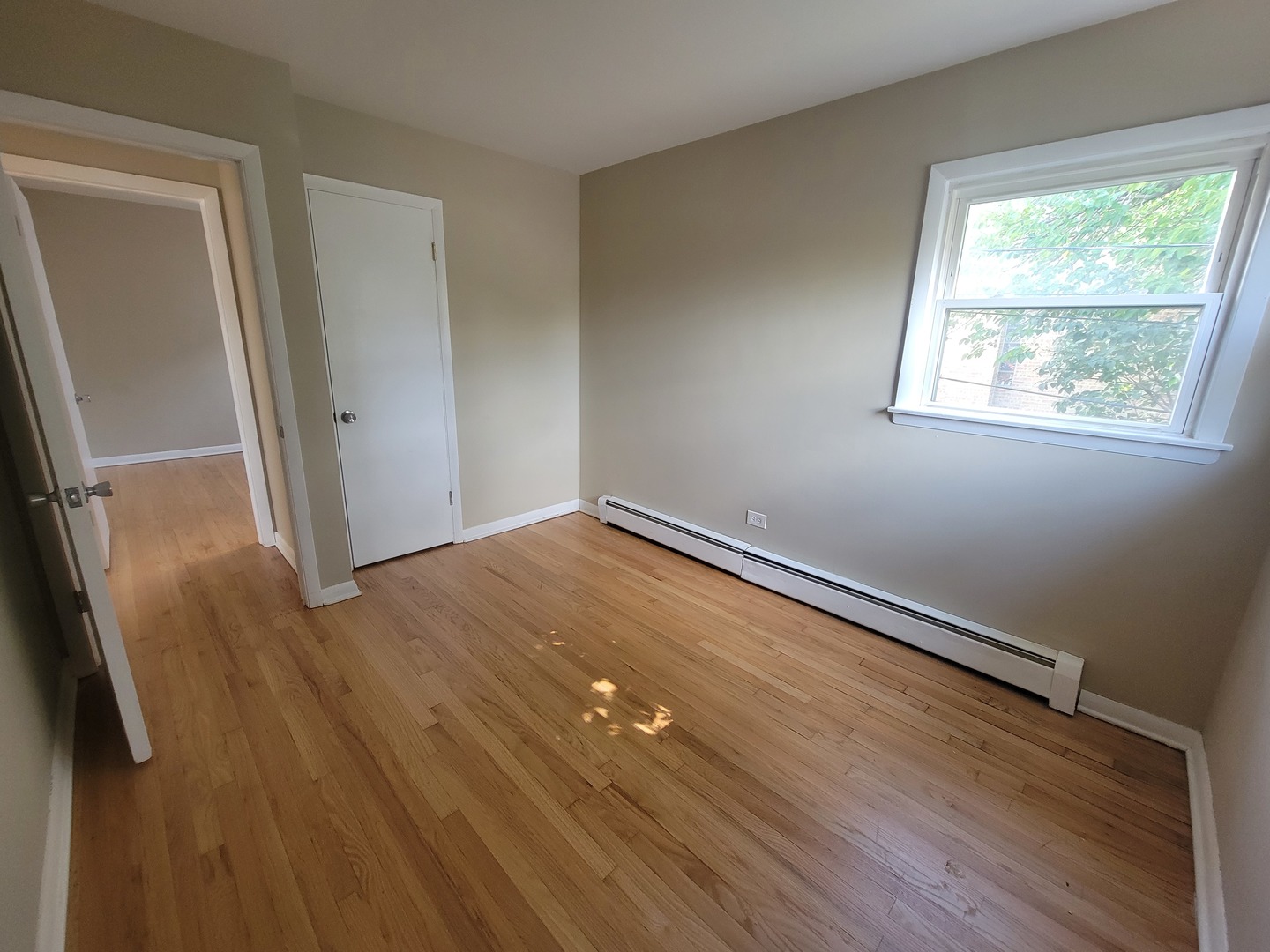 5237 West Roscoe Street Chicago, IL 60641 - Photo 10 of 27 a view of empty room with wooden floor and fan