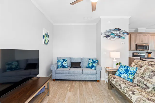 a living room with furniture and a chandelier