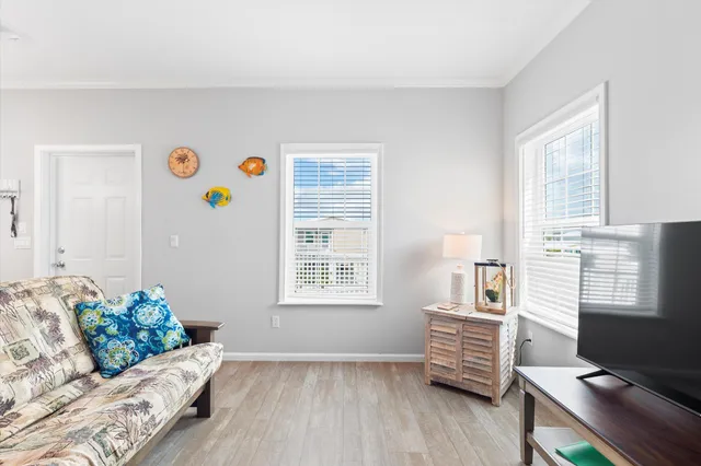 a bedroom with a bed and a table with a potted plant