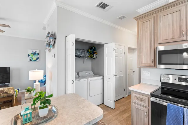 a kitchen with kitchen island a white cabinets and refrigerator