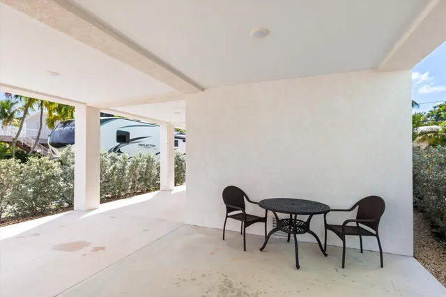a view of a chairs and table in a patio