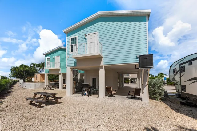 a view of a patio with a table chairs and a porch