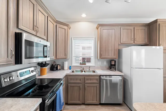 a kitchen with a sink stove and cabinets