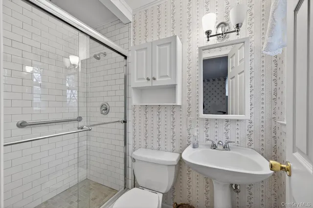a bathroom with a sink toilet and shower