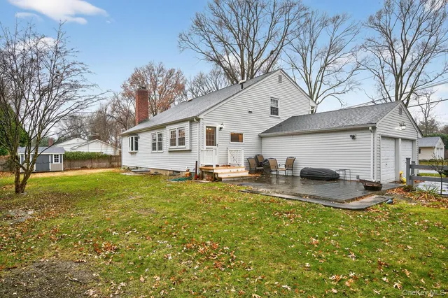 a view of a house with backyard and sitting area