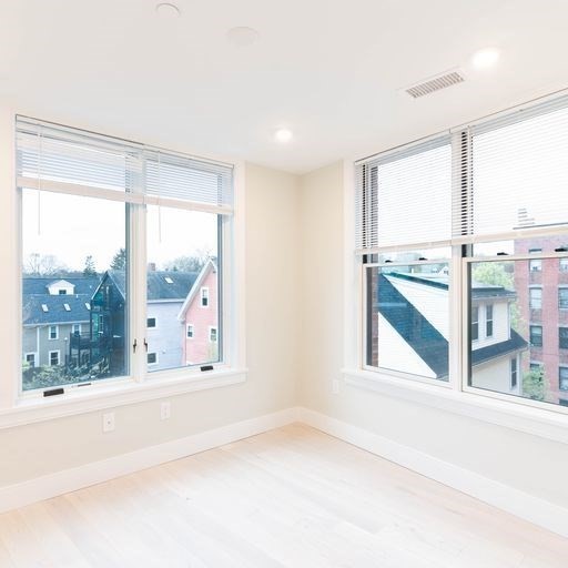 197 Green Street, Unit 303 Boston, MA 02130 - Photo 5 of 6 a view of an empty room with a window