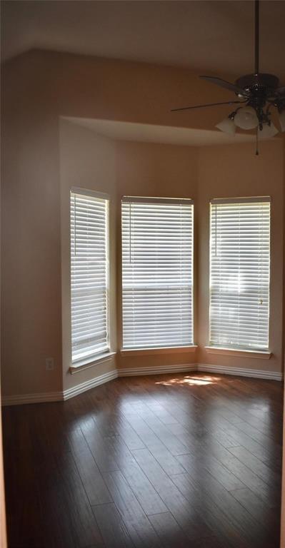 384 Spring Meadow Drive Fairview, TX 75069 - Photo 13 of 16 an empty room with wooden floor and windows