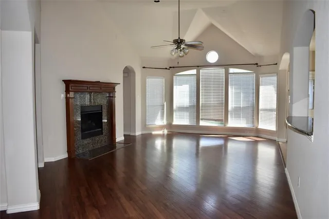 a view of an entryway with wooden floor fireplace and a window