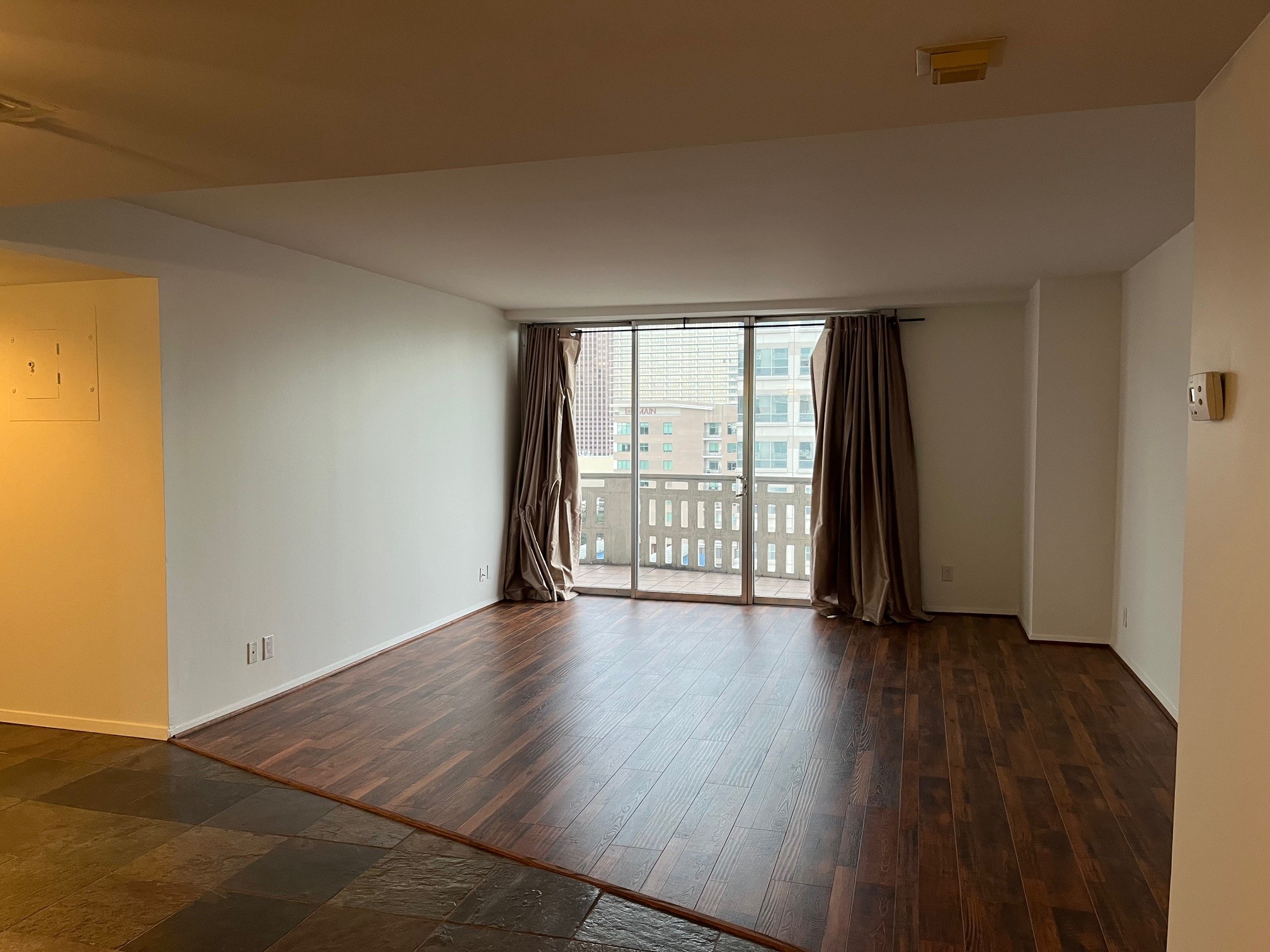 2016 Main Street, Unit 1005 Houston, TX 77002 - Photo 1 of 8 an empty room with wooden floor and windows