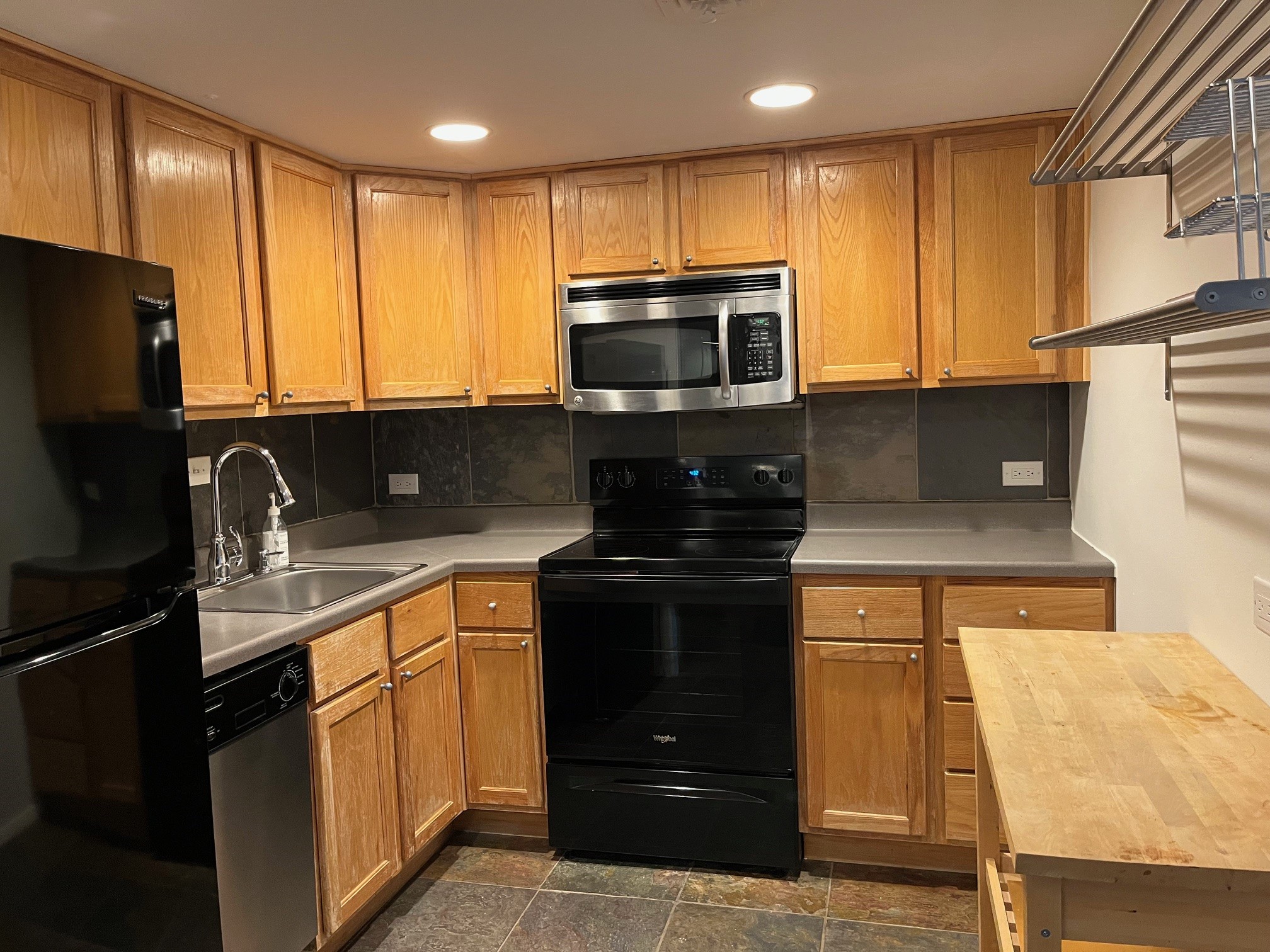 2016 Main Street, Unit 1005 Houston, TX 77002 - Photo 3 of 8 a kitchen with stainless steel appliances granite countertop a stove a sink and a microwave