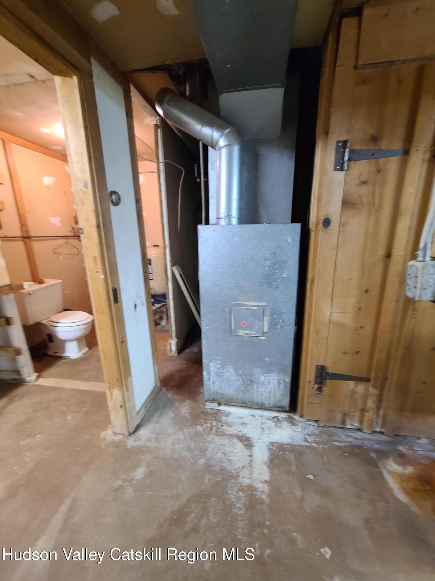 153 Shore Road Swan Lake, NY 12783 - Photo 24 of 45 a view of a hallway with wooden walls and door