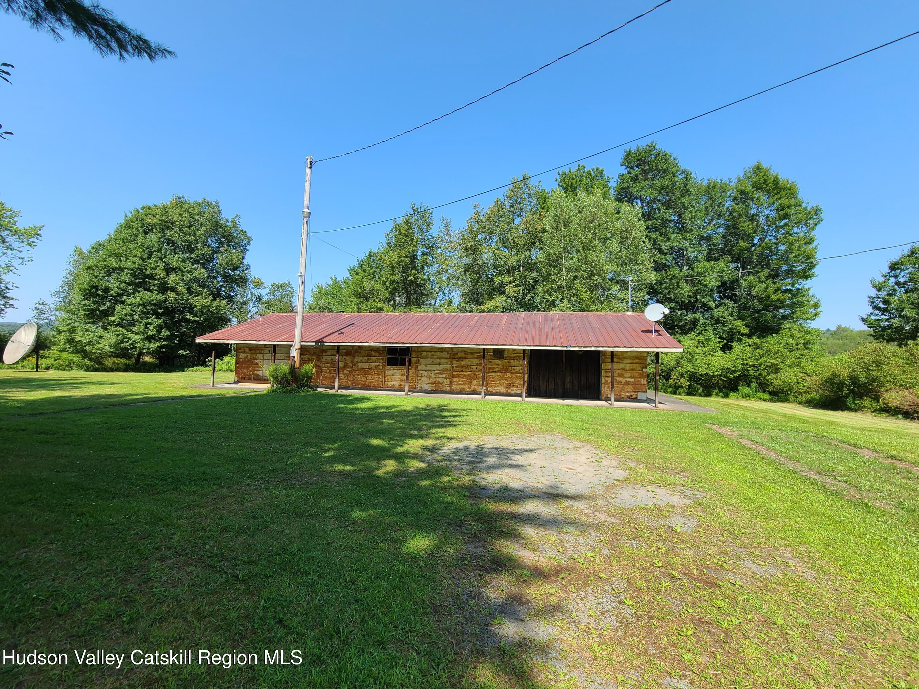 153 Shore Road Swan Lake, NY 12783 - Photo 3 of 45 a view of a big yard with a house in the background