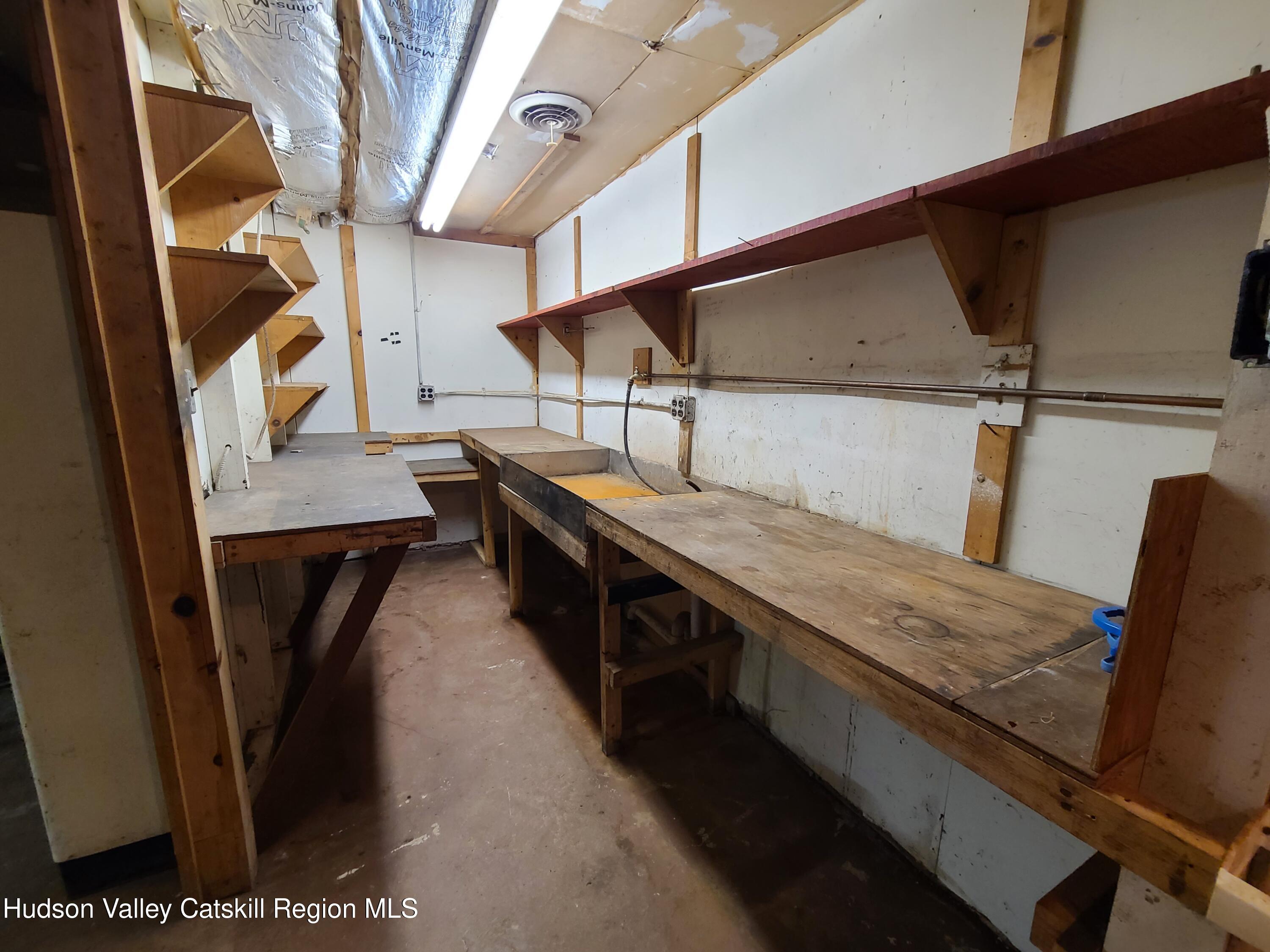 153 Shore Road Swan Lake, NY 12783 - Photo 32 of 45 a kitchen with a sink a refrigerator and washer