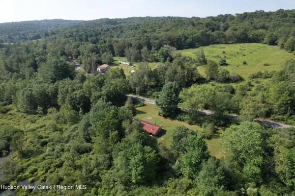 an aerial view of a house with mountain view