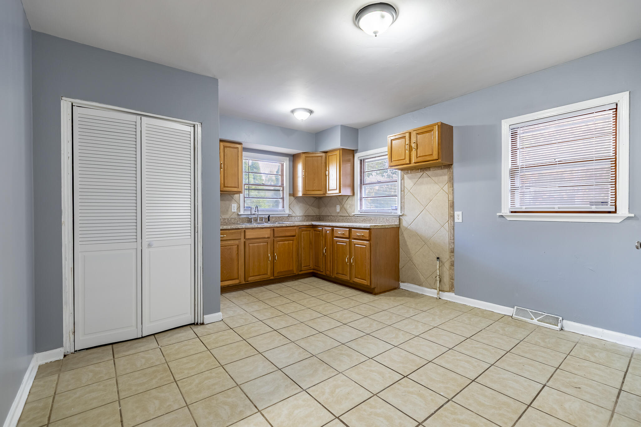 4836 Madison Street Gary, IN 46408 - Photo 11 of 21 a kitchen with stainless steel appliances a sink and cabinets