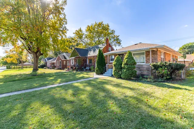 a front view of house with yard and green space