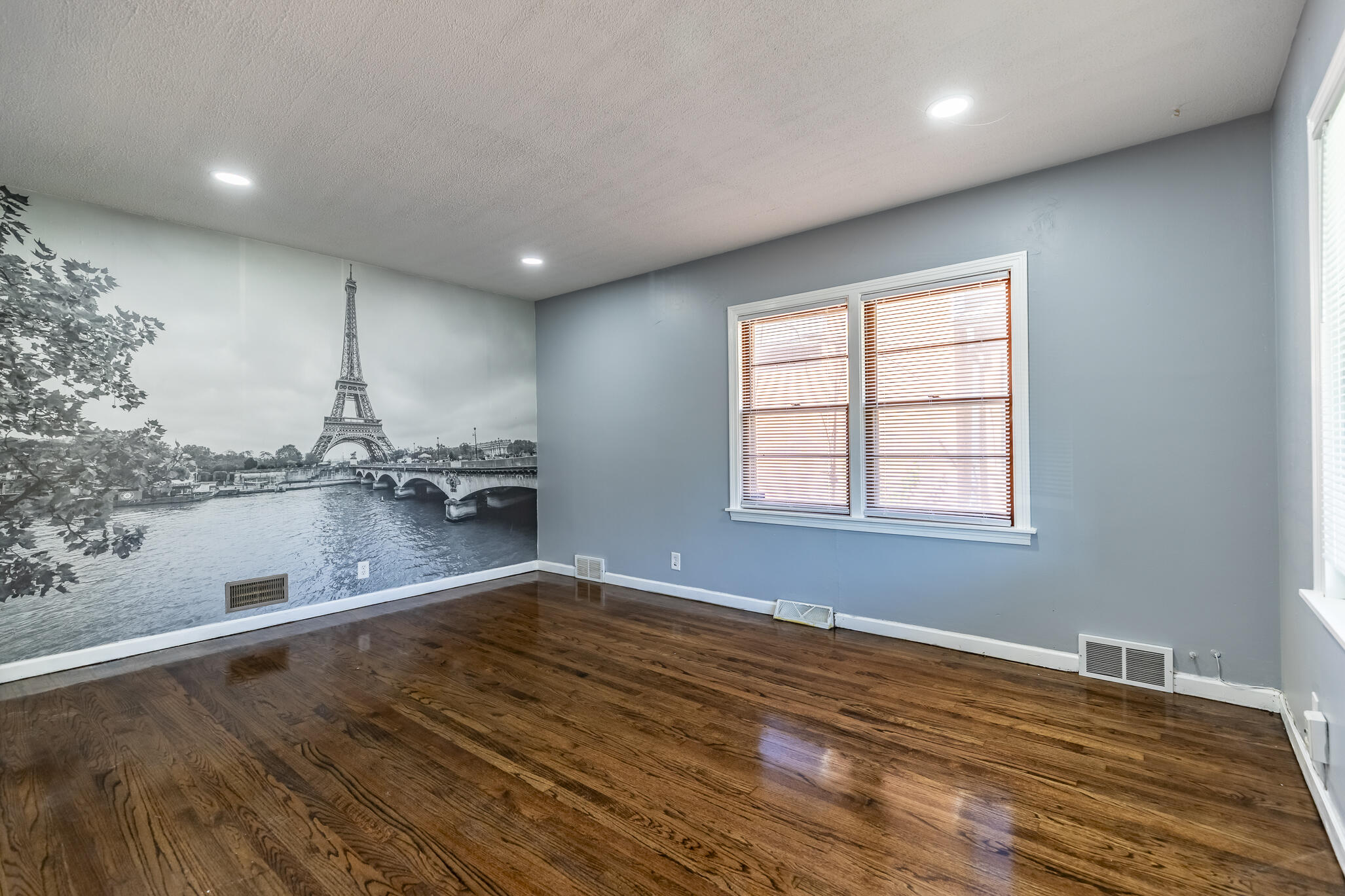 4836 Madison Street Gary, IN 46408 - Photo 7 of 21 a view of empty room with wooden floor and fan